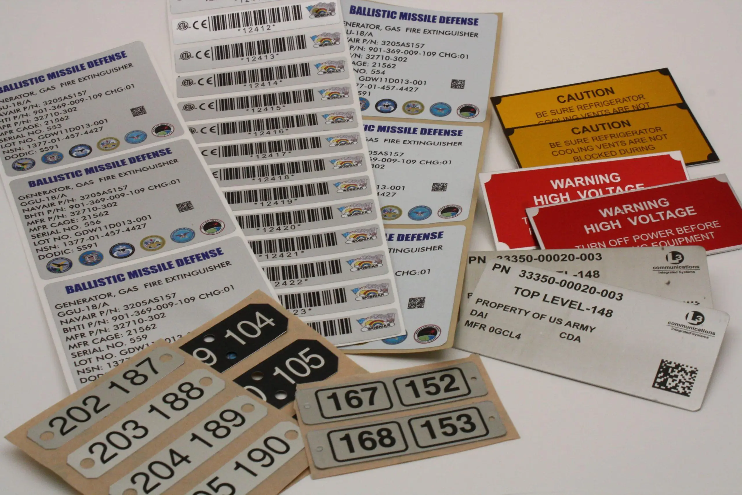 Custom durable labels with barcodes and warning graphics, manufactured in the Bay Area for industrial and military equipment.