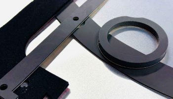 Black foam die-cut gasket and spacer components manufactured near San Jose, CA for sealing and vibration dampening.