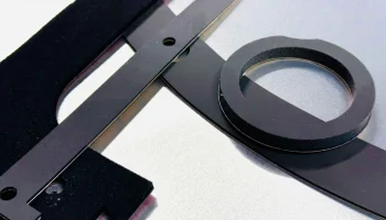 Black foam die-cut gasket and spacer components manufactured near San Jose, CA for sealing and vibration dampening.