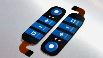 Flexible membrane switch with custom graphic overlay and tail connector for compact device integration.