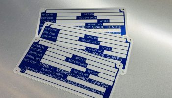 Anodized aluminum nameplates for aerospace applications with variable data fields, produced near San Jose, California.