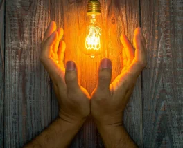 Energy industry innovation symbolized by illuminated bulb, representing durable and compliant labeling solutions from Melrose