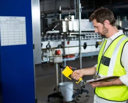 Technician using test and measurement equipment with custom components for calibration and data recording